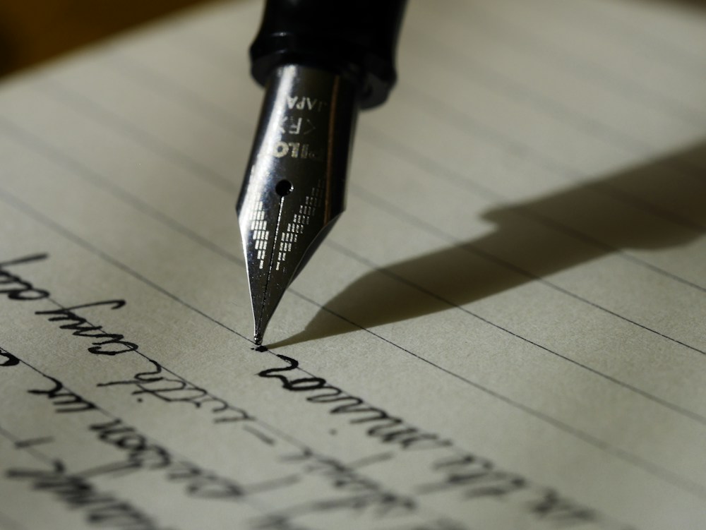 Notebook and writing materials on a calm wooden desk
